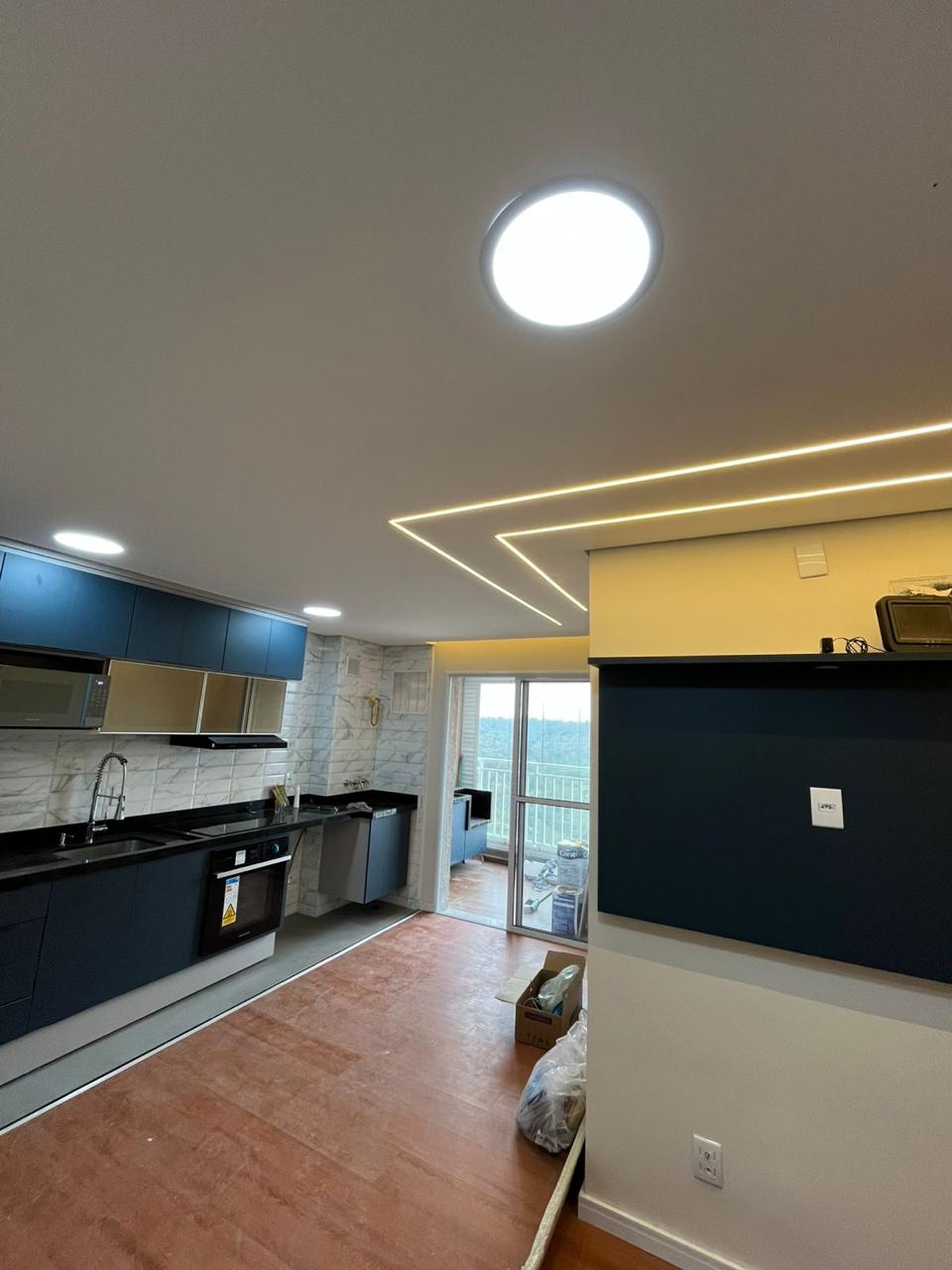 Cozinha planejada azul com vista para a varanda